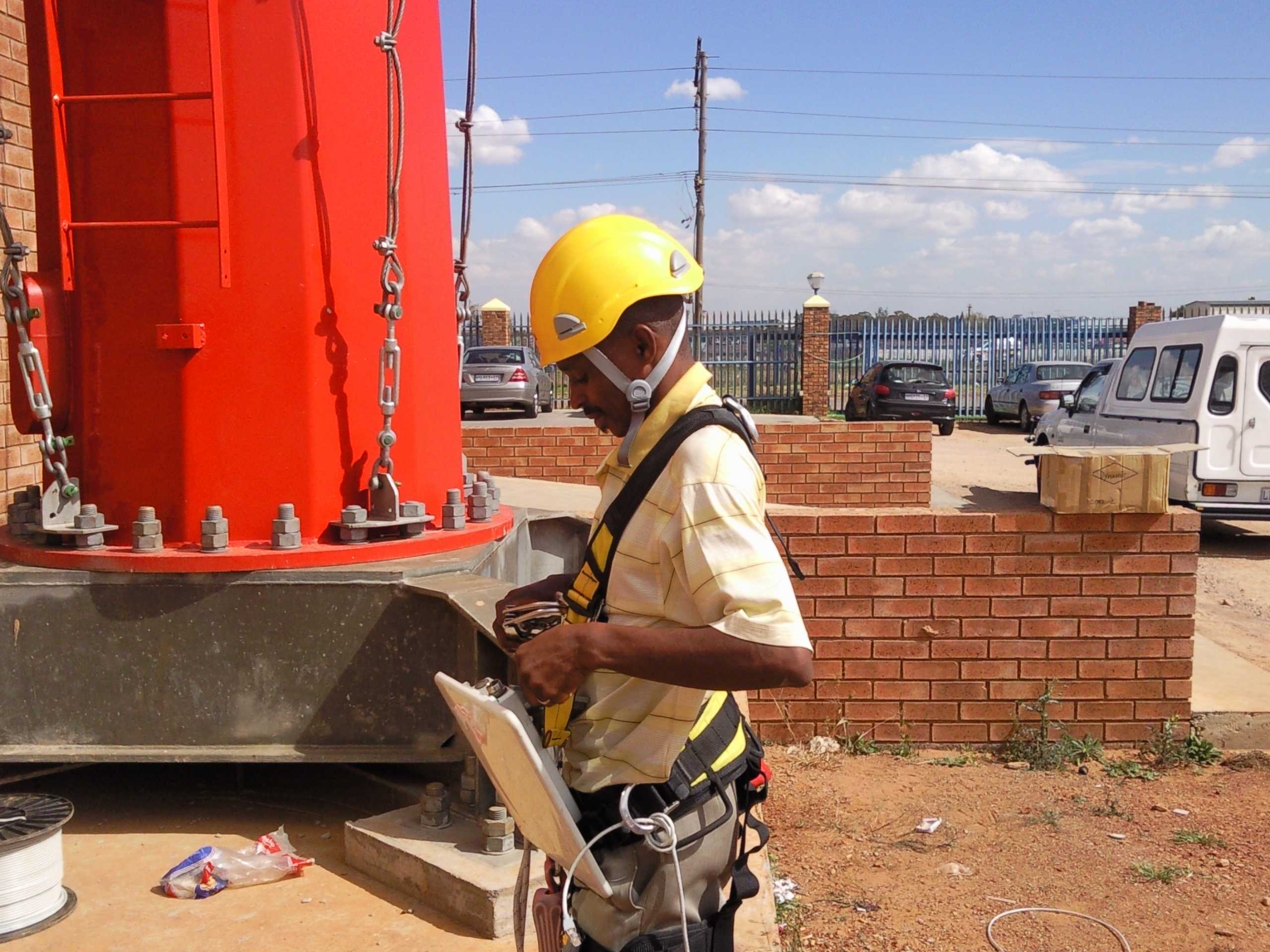 Man putting on climbing harness